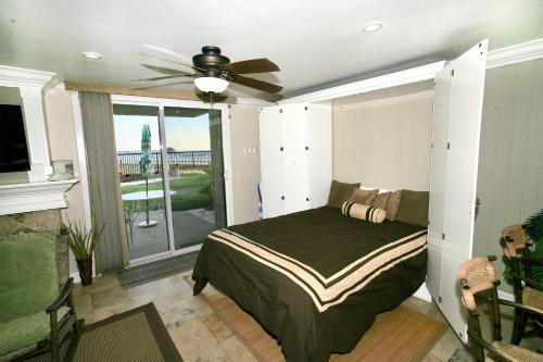 a bedroom with a bed and a ceiling fan at D11 - Beachfront Luxury in Oceanside
