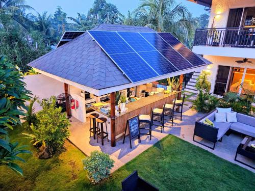 an image of a house with solar panels on the roof at Hazel's Suites in Dauin
