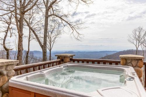 a jacuzzi tub on a deck with a view at Good Day Sunshine in Lenoir