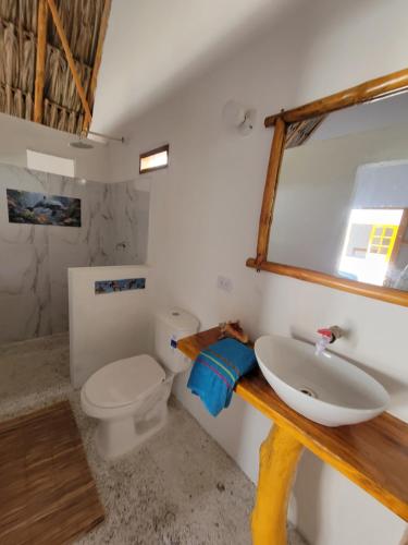 a bathroom with a sink and a toilet at Karpatty Mar Cabañas in San Bernardo del Viento