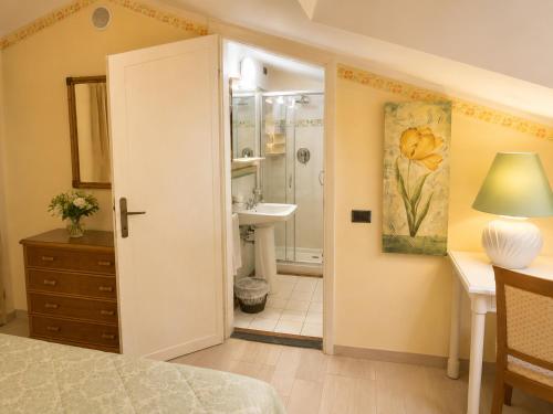 a bedroom with a bathroom with a sink and a shower at Hotel Kyrton in Forte dei Marmi