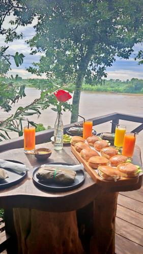 a table with a tray of bread and orange juice at Bunker de niker in Puerto Maldonado