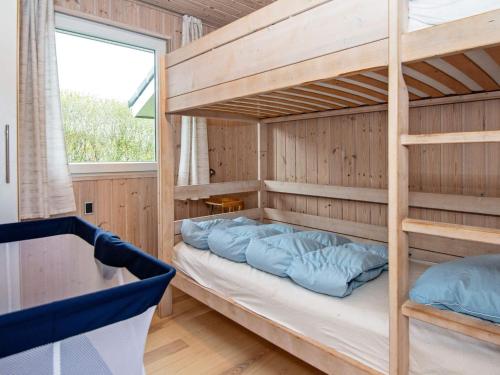 a bunk bed with blue pillows in a room at Luxury Retreat in Hejlsminde in Hejls