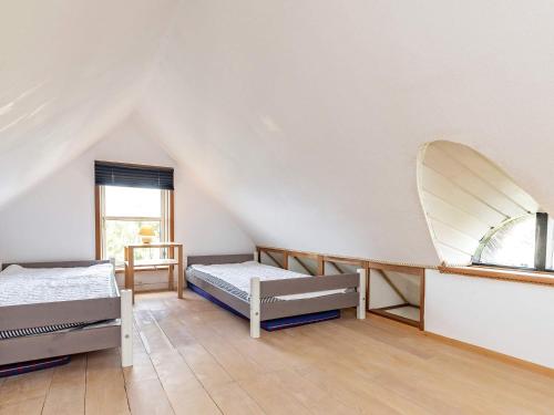a room with two beds and a window at Charming cottage near forest in Farsø in Farsø