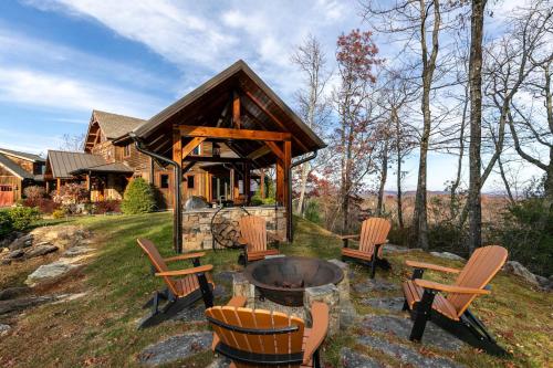 a group of chairs around a fire pit in front of a house at Bailey's Creek Lodge in Lenoir