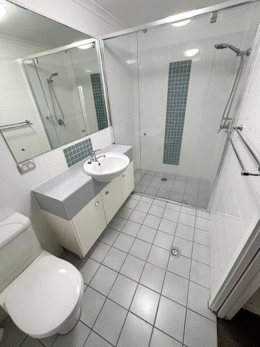 a bathroom with a toilet and a sink and a shower at Jubilee Apartment 03 - Bring your own linen in South West Rocks