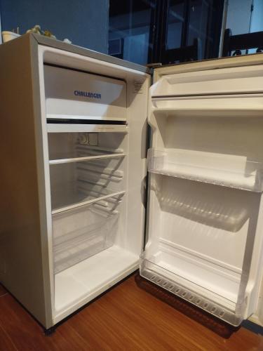 an empty refrigerator with its door open in a room at Apartaestudio confortable 1 en Combia in Pereira