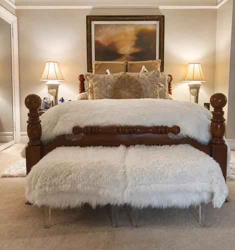 a bedroom with a large bed with white blankets and pillows at Luxury Pre-War Townhouse Bronx 5BR in University Heights