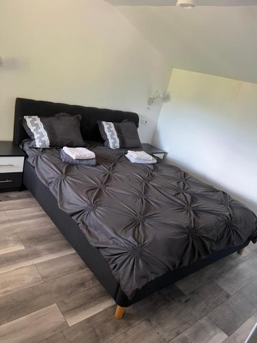 a bed with two pillows on it in a bedroom at Casa ALBERT in Brezoi