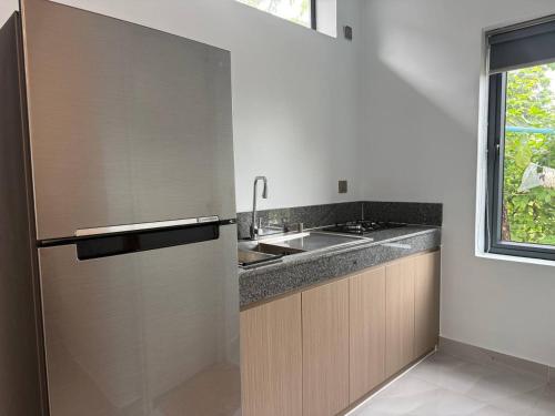 a kitchen with a refrigerator and a sink at Family Motel in Bahal