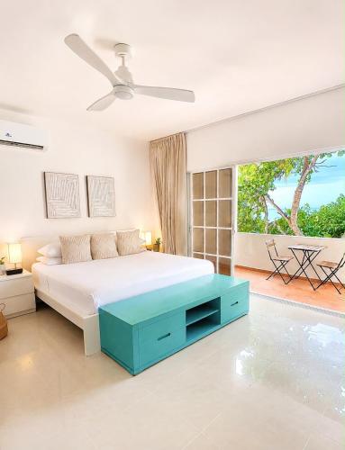 a white bedroom with a large bed and a window at Blue Island Punta Rucia in Punta Rucia