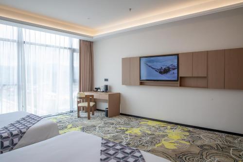 a hotel room with a bed and a desk at The MAJULAN Hotel in Kota Kinabalu
