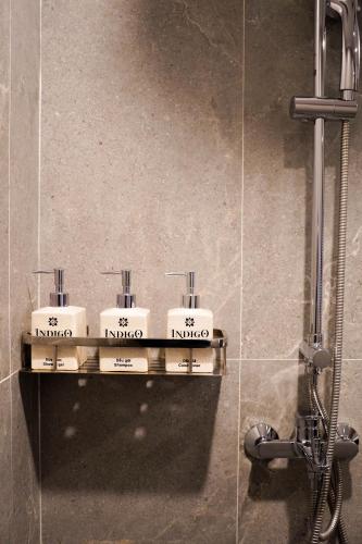 a bathroom with three sinks and a shower at Indigen Boutique Hotel Cao Bang in Cao Bằng