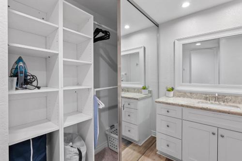 a white bathroom with two sinks and a mirror at G207 - Surfer's Hideaway in Oceanside