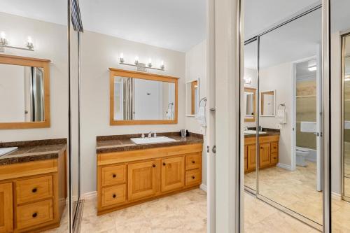 a bathroom with two sinks and a shower at A217 - Blue Water Escape in Oceanside