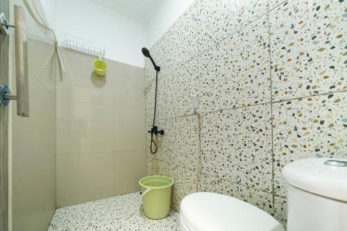 a bathroom with a shower and a toilet at JM Tuparev Mitra RedDoorz in Karawang
