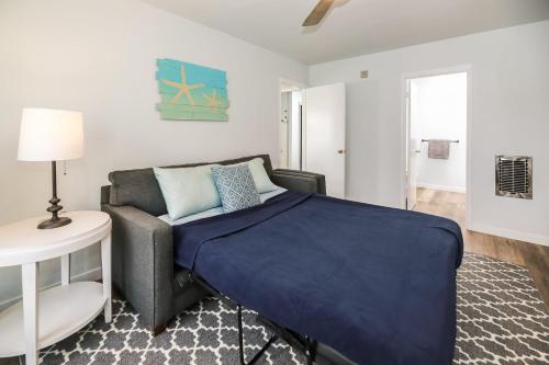 a bedroom with a bed and a couch at Pacifica Strand Unit 15 in Oceanside