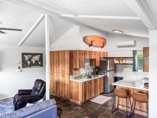 a kitchen with wooden cabinets and a counter top at Coral Wave Cottage in Waialua