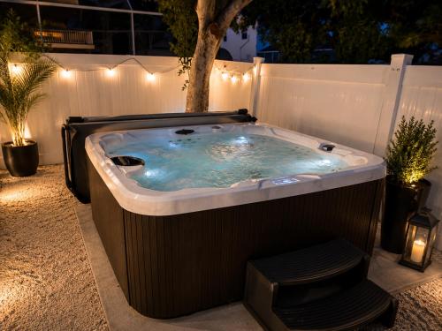a jacuzzi tub in a backyard at night at Sunwashed Stone Villa with Heated Pool, Hot Tub & Mini Golf in Bradenton