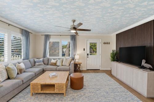 a living room with a couch and a flat screen tv at Sunwashed Stone Villa with Heated Pool, Hot Tub & Mini Golf in Bradenton