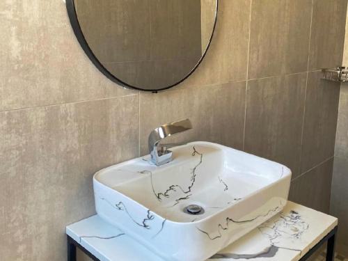 a bathroom with a sink and a mirror at MRF Lodge in Louis Trichardt