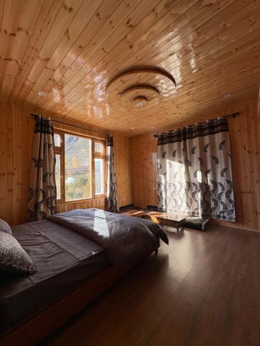 a bedroom with a large bed and a window at Shubham homestay in Sissu