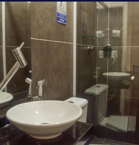 a bathroom with a toilet and a glass shower at iHostel Aldeota in Fortaleza