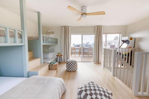 a bedroom with a bed and a staircase with a crib at B304 - The Lookout in Oceanside