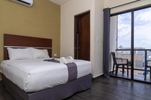 a bedroom with a large bed and a balcony at REGMAR Progreso Yucatán in Progreso