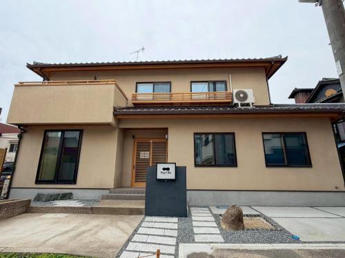 a house with a balcony on top of it at KUON Onomichi - クオン尾道 in Onomichi