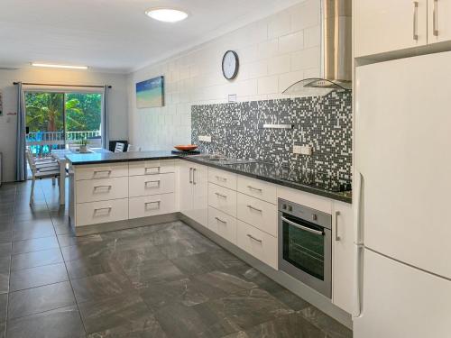 a kitchen with white cabinets and a counter top at Arcadia Beach Unit 3 in Arcadia