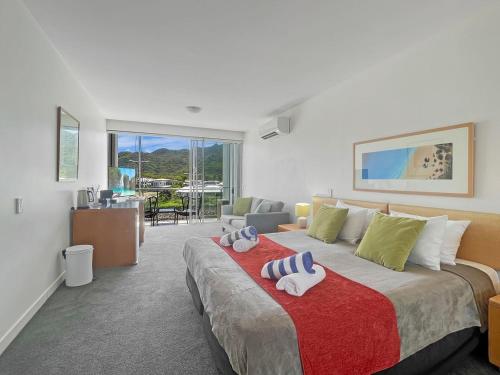 a bedroom with a large bed with towels on it at Blue on Blue Studio Room 1352 in Nelly Bay
