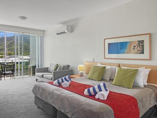 a bedroom with a large bed with towels on it at Blue on Blue Studio Room 1352 in Nelly Bay