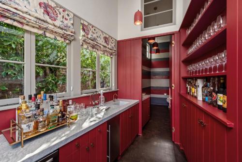 a red kitchen with red cabinets and windows at Howard Hughes Estate in Los Angeles