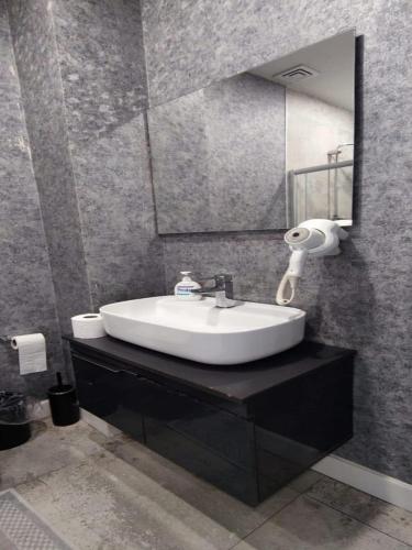 a bathroom with a sink and a mirror at Kent Suites Hotels Ataşehir in Istanbul
