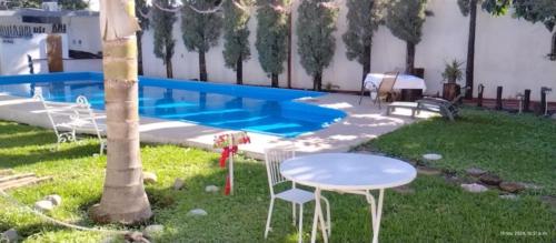 a backyard with a table and chairs and a pool at Bolet in Monterrey