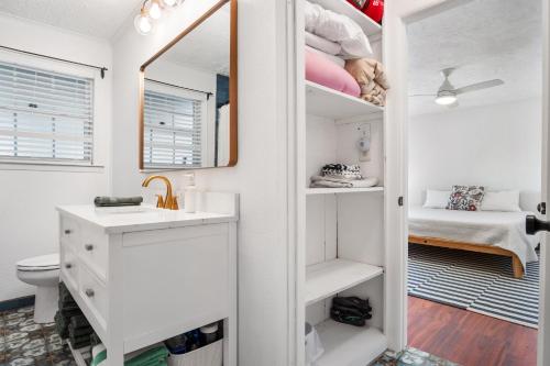 a bathroom with a sink and a toilet and a mirror at Nueces River Escape in Uvalde