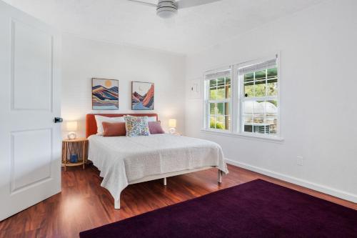 a white bedroom with a bed and a window at Nueces River Escape in Uvalde