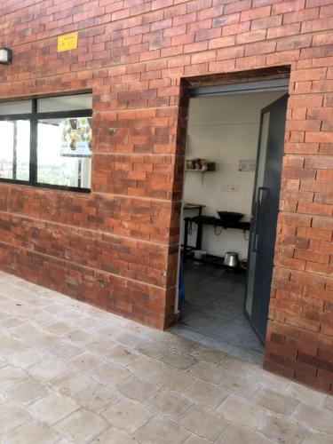 a brick wall with a door in a building at Tsavo Stanley, Kiambu La Mayan in Kiambu