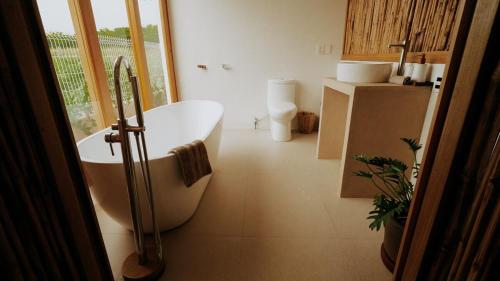a bathroom with a bath tub and a sink at Aguamiel Agua Blanca in Playa Agua Blanca