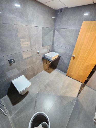 a bathroom with a toilet and a sink at hotel vistara luxe in Himatnagar