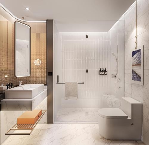 a bathroom with a tub and a toilet and a sink at Mercure Bangkok Siam Ratchathewi in Bangkok