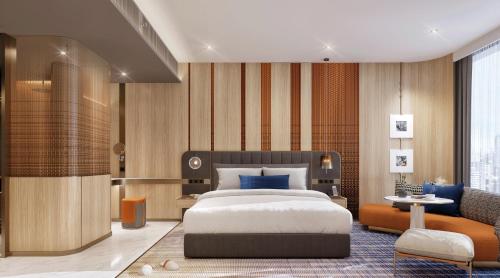 a bedroom with a king sized bed and a living room at Mercure Bangkok Siam Ratchathewi in Bangkok