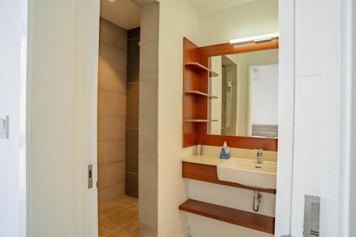 a bathroom with a sink and a mirror at Ebene City Centre - 2 Bedroom Apartment in Ebene