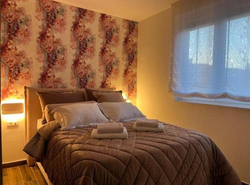 a bedroom with a large bed with two towels on it at Deluxe Apartment Bono in Sinj