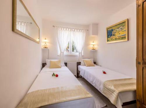 a bedroom with two beds with flowers on them at Villa Pax in Studenci