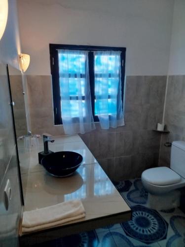 a bathroom with a sink and a toilet at Castello in Anakao