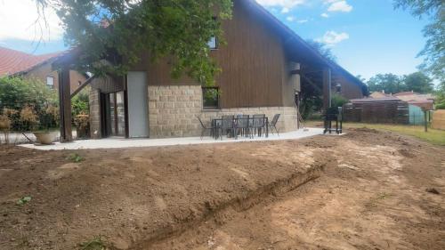 a house with a dirt yard in front of it at Maison familiale in La Souterraine
