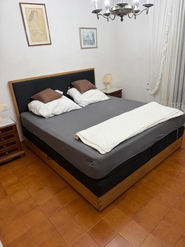 a bedroom with a large bed with a black frame at Calafell Residencial in Calafell