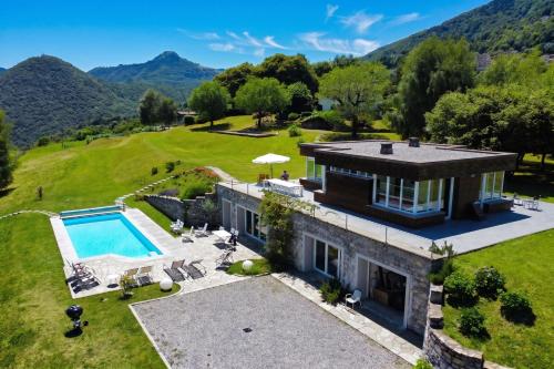 an aerial view of a house with a swimming pool at Villa Intelvi in Castiglione dʼIntelvi
